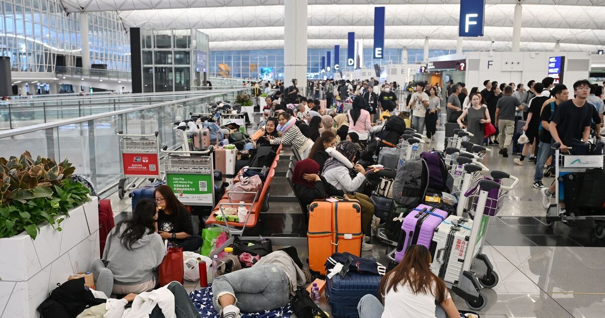 Watch: passengers thrown to their knees while attempting to board planes in 145mph typhoon
