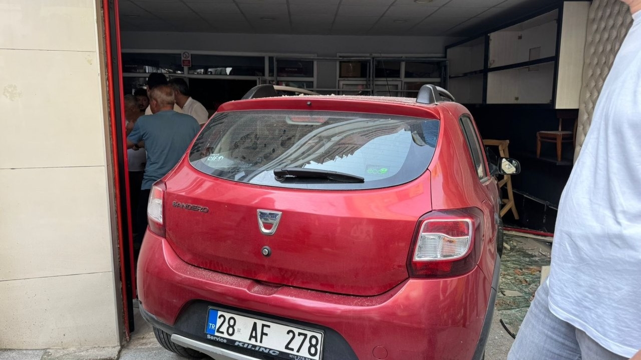 A female driver crashed into a shop, leaving one person trapped under the vehicle.